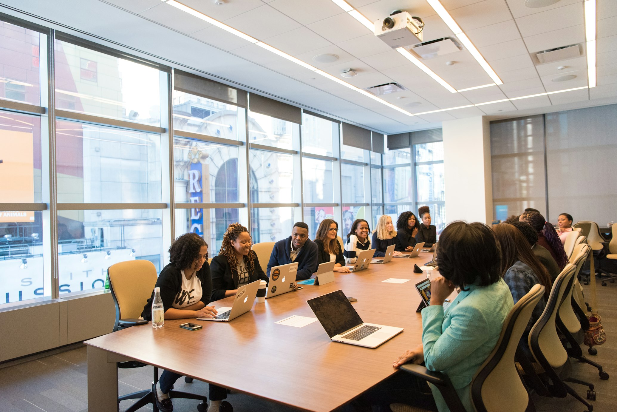 Team of professionals analyzing data and charts in modern conference room environment